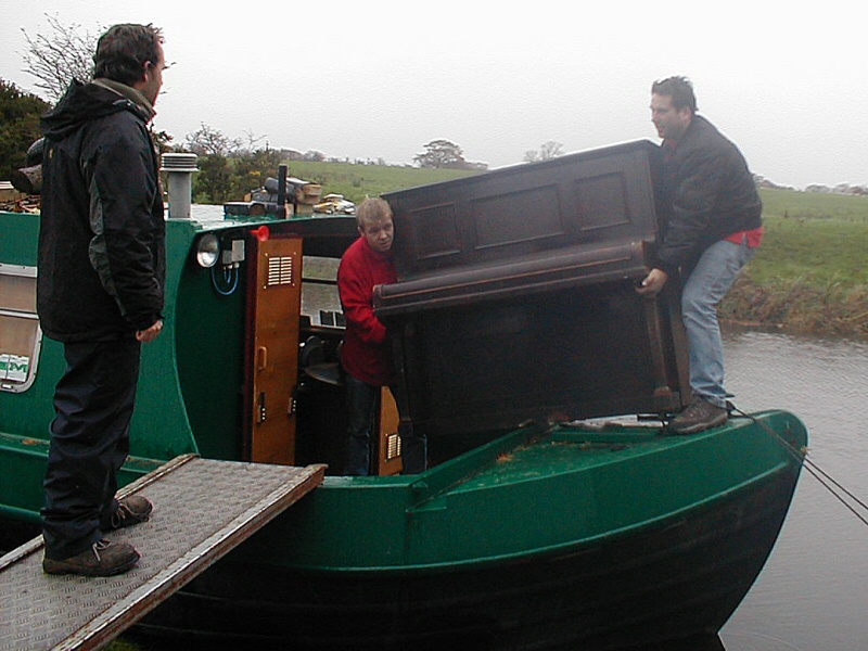 Think you have a challenging job? Moving an upright piano onto a canal barge on the Lancaster Canal.